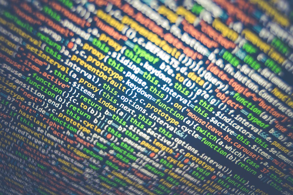 A close-up image of computer code displayed on a screen, featuring multicolored text in various shades of green, yellow, orange, and blue, with a focus on JavaScript programming syntax including keywo